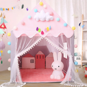 Tipi rose décoré avec des pompons colorés, des nuages et des gouttes de pluie en feutrine, avec des coussins en forme de maisons et une lampe en forme de lapin à l'intérieur, créant un espace de jeu magique pour enfants.